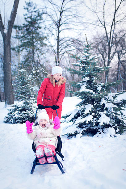 istock Happy mother and baby playing outdoors in winter 629170514