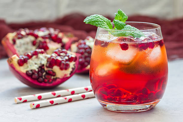 Mojito cocktail with pomegranate, mint, lemon juice and ice, horizontal stock photo