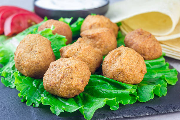 istock Chickpea falafel balls on slate board with vegetables and sauce 629172064