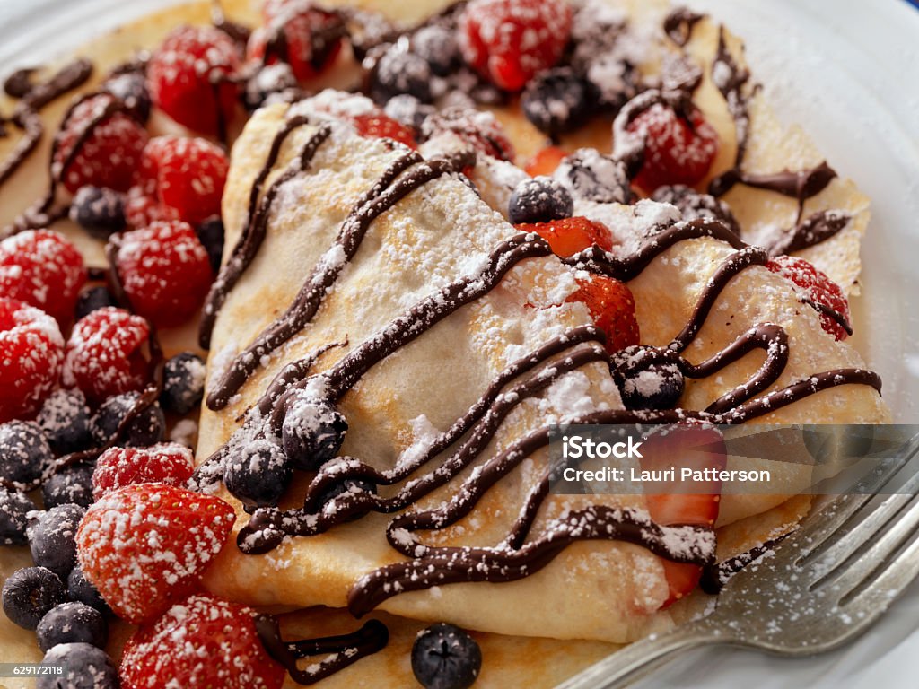 Crepes with Fresh Berries, Chocolate Sauce and Powdered sugar Crepes with Fresh Berries, Chocolate Sauce and Powdered sugar -Photographed on a Hasselblad H3D11-39 megapixel Camera System Crêpe - Pancake Stock Photo