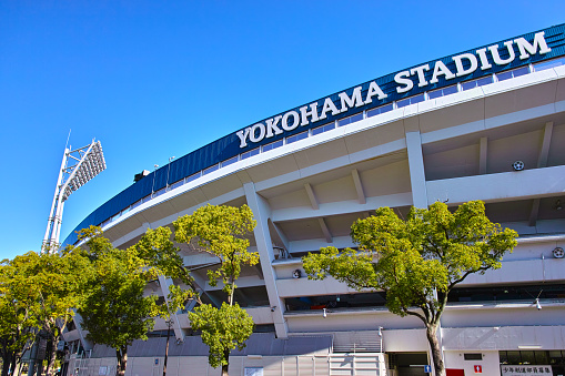 Yokohama, Japan - December 10, 2016: Yokohama Stadium seen from within Yokohama Park on the side of Kannai Station. Central league baseball team, home of Yokohama DeNA Baystars. Yokohama Stadium opened in 1978 and has been sponsored by DeNA since 2012.