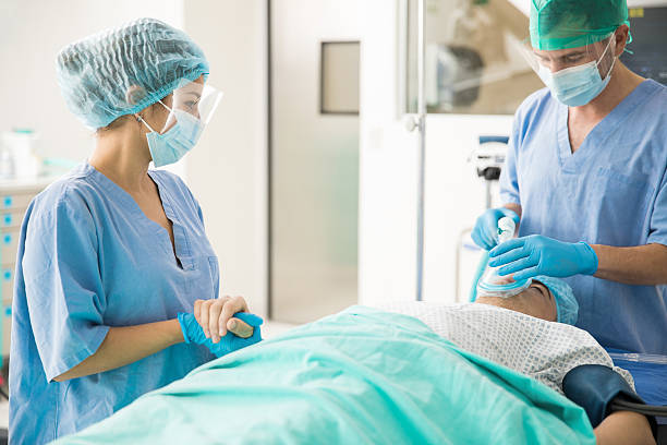 tomar de la mano a un paciente antes de la cirugía - anestesista fotografías e imágenes de stock
