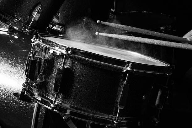 The man is playing drumset The man is playing drumset in low light background. drum percussion instrument photos stock pictures, royalty-free photos & images