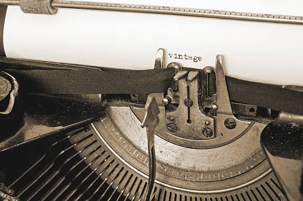 Close up of old typewriter and vintage text on paper, sepia style