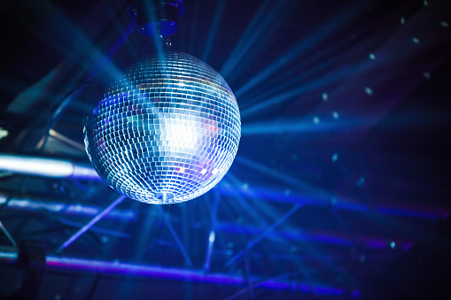Disco ball with blue rays, night party background photo