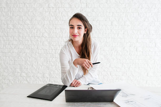 istock Female designer looking at camera on workplace 629187080
