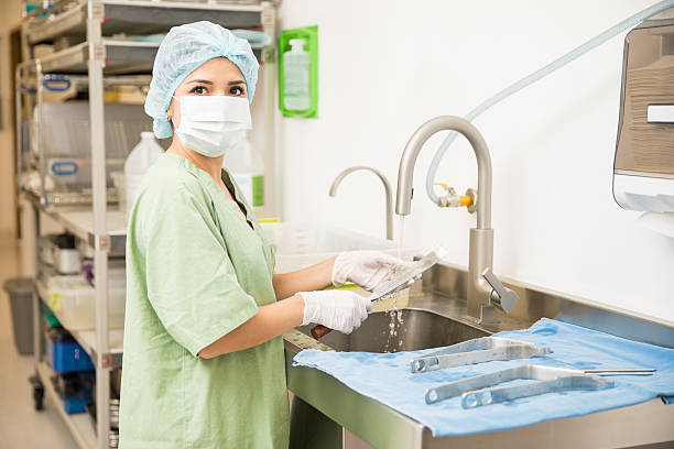 istock Pretty woman cleaning medical tools 629187268