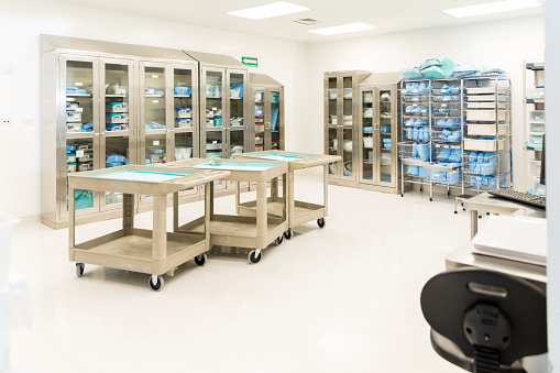 Wide view of a storage room with clean and sterile medical instruments and clothing in a hospital