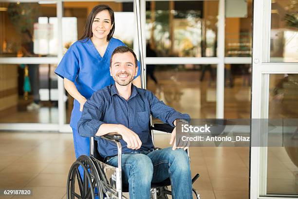 Recovered Patient Leaving The Hospital Stock Photo - Download Image Now - Hospital, Leaving, Wheelchair