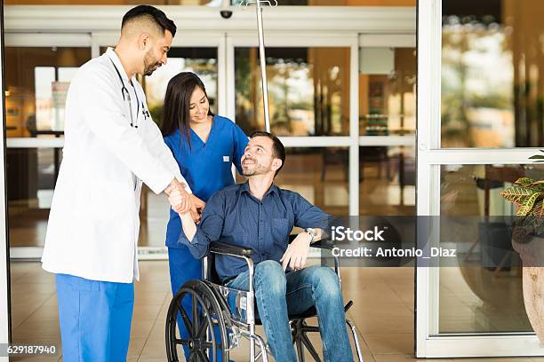 Patient Leaving The Hospital On A Wheelchair Stock Photo - Download Image Now - Hospital, Leaving, Patience