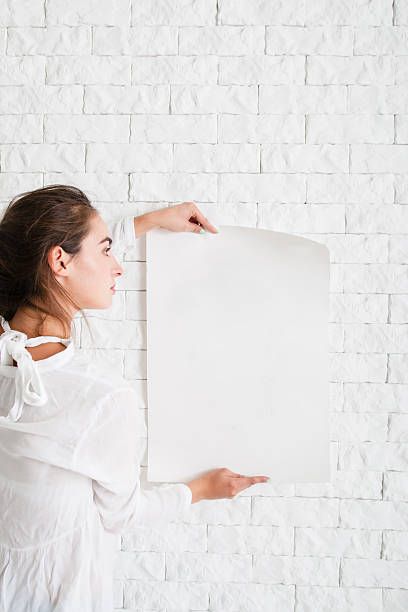 istock Young woman looking at empty sheet of paper 629201748