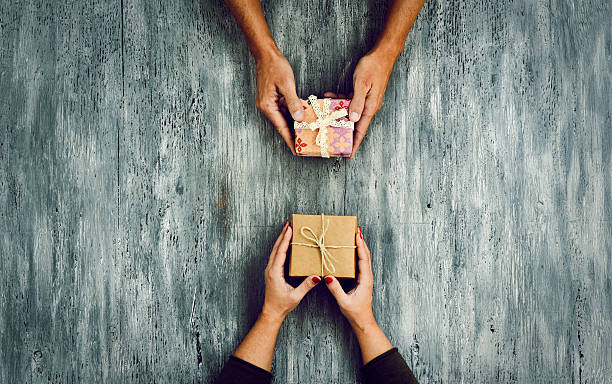 woman and man exchanging gifts