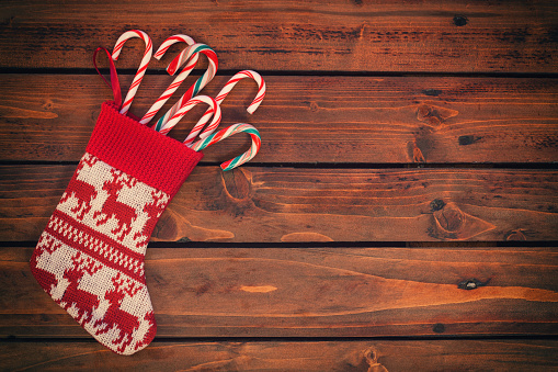 Christmas stockings with candy cane on the old wooden background