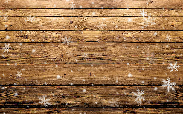 wooden background with snowflakes stock photo