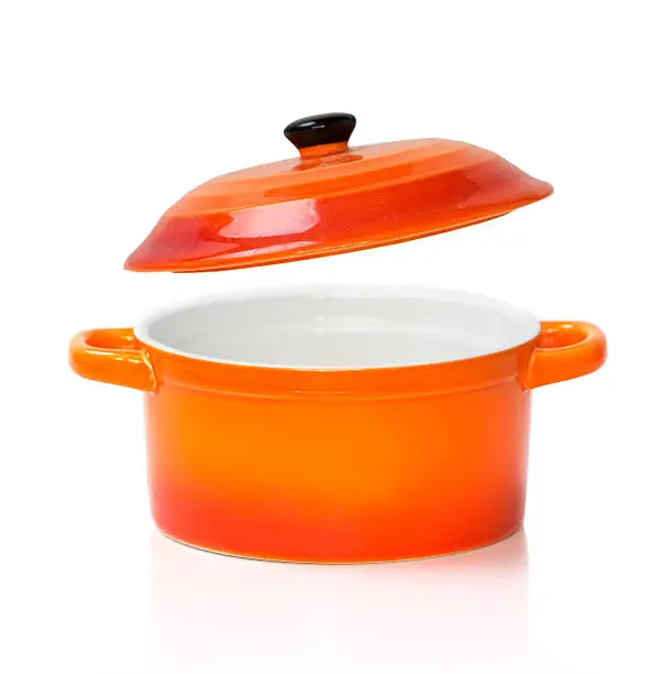 Orange red ceramic cooking kitchen pot pan with an open cover opened isolated on white.