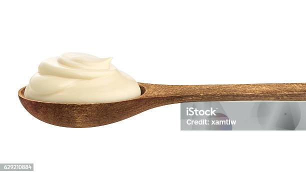 Sour Cream In Wooden Spoon Isolated On White Background Stock Photo - Download Image Now