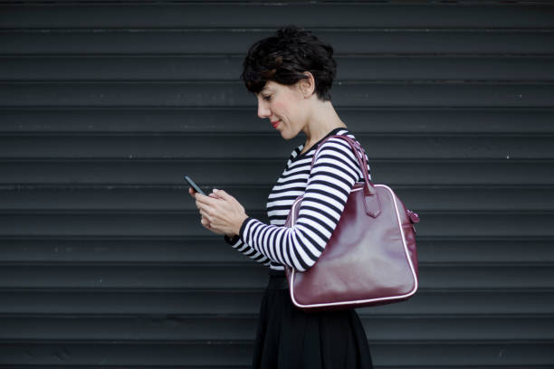 istock woman looking at mobile phone 629211938