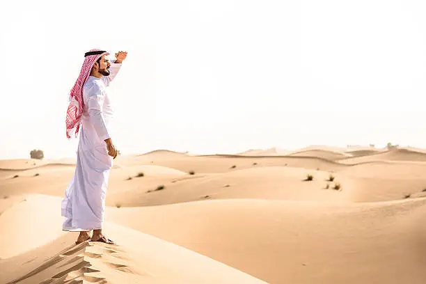 Photo of arabic sheik on the desert look forward