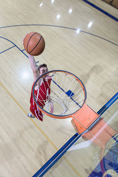 High school male dunking a basketball