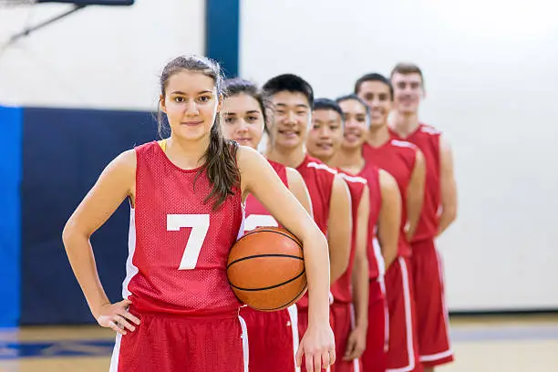 Photo of Diverse group of co-ed basketball players in a line