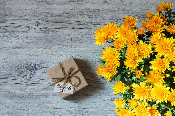 istock bouquet of yellow chrysanthemums with a gift 629214178
