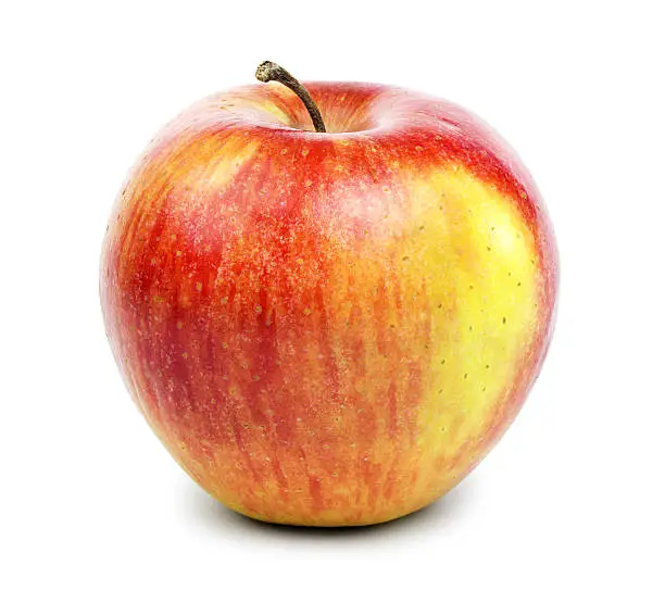 Ripe red-yellow apple with a striped pattern isolated on white background.