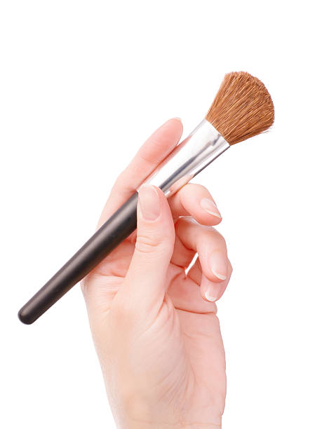 istock Hand holding cosmetic brush 629216406