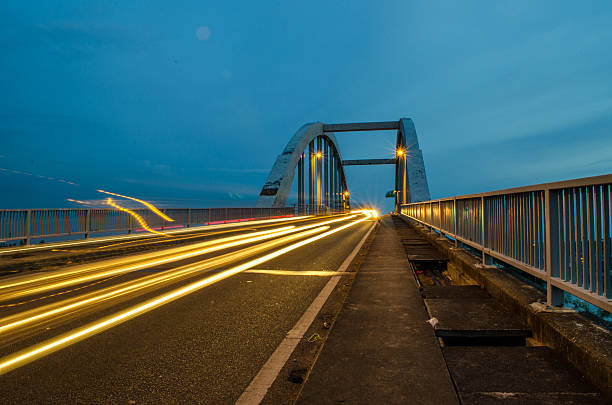 istock Old Bridge crossing sea with light trail. 629217804
