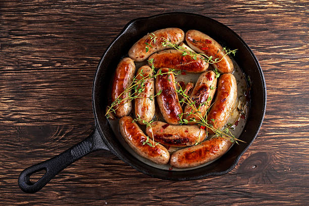 istock Home-made Pork Sausages in rustic pan with thyme 629218942