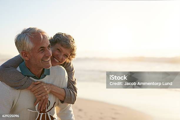 Senior Par Divirtiéndose En La Playa Foto de stock y más banco de imágenes de Tercera edad - Tercera edad, Parejas, Jubilación