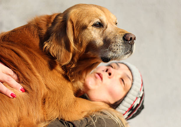 istock young girl hugging her dog 629225248