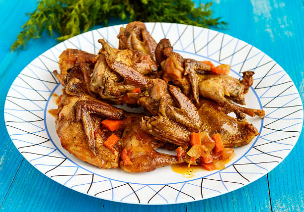 istock Quail stew with vegetable gravy on a blue wooden table. 629227976