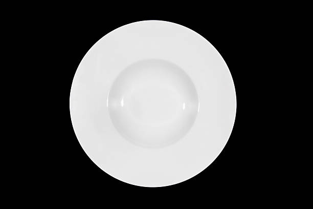 istock Deep soup plate with shoulders on black background from above 629228044