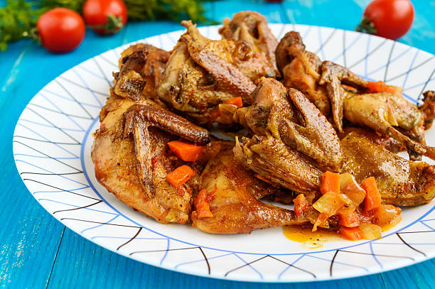 istock Quail stew with vegetable gravy on a blue wooden table. 629228084