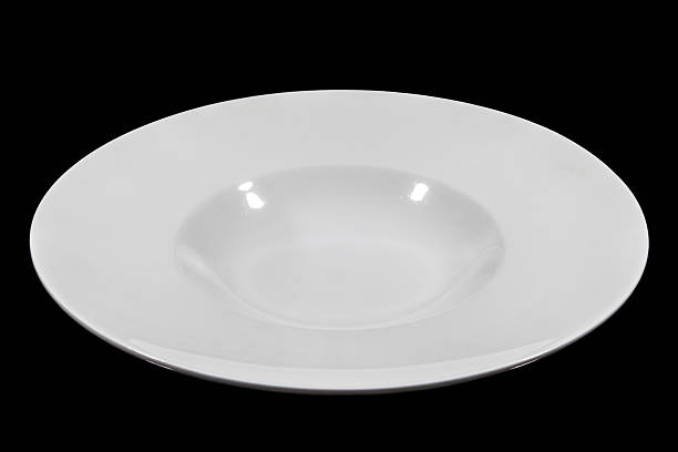 istock Deep soup plate with shoulders on black background from side 629228170