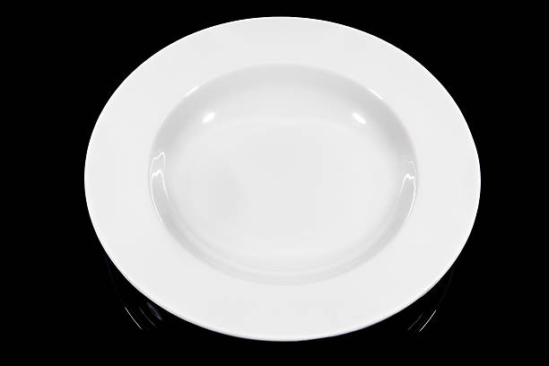 istock Soup deep round plate on black background from high angle 629228316