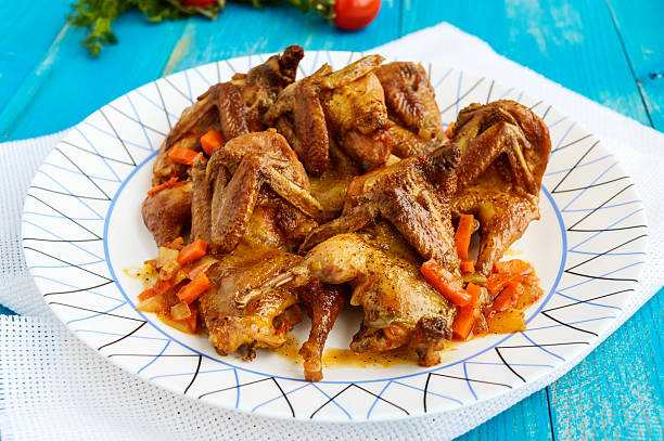 istock Quail stew with vegetable gravy on a blue wooden table. 629228392