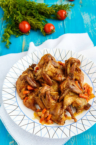 istock Quail stew with vegetable gravy on a blue wooden table. 629228518