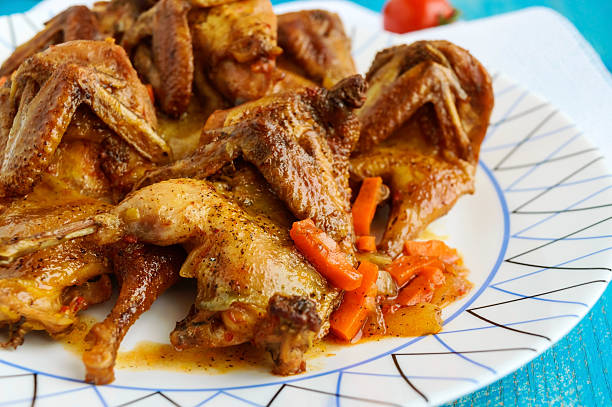 istock Quail stew with vegetable gravy on a blue wooden table. 629228614