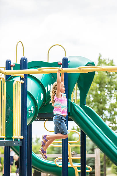 istock Girl Making Her Way Across Monkey Bars at Playground 629230316