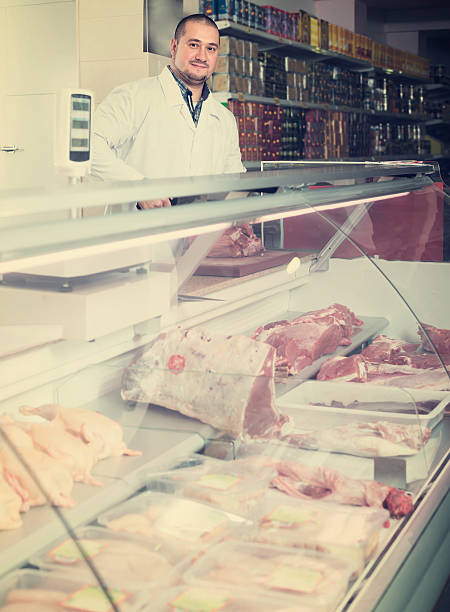 istock Man seller at the counter with meat 629230766