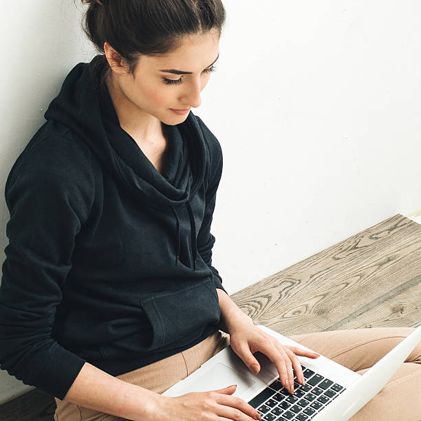 istock Young beautiful woman with laptop on floor. 629230772