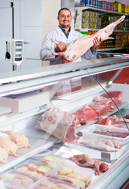 istock Man seller at the counter with meat 629230840