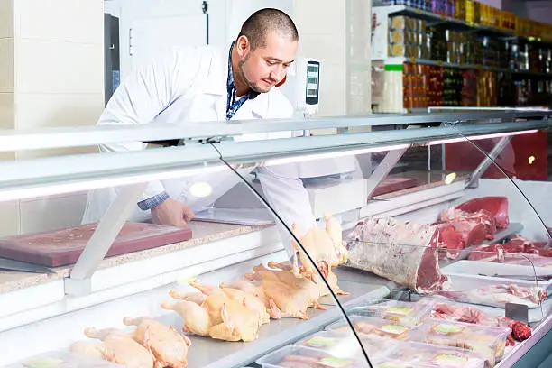 Photo of Male seller in halal section at supermarket