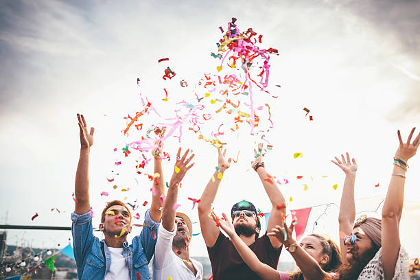 istock Joyful friends with confetti at the rooftop party 629237690