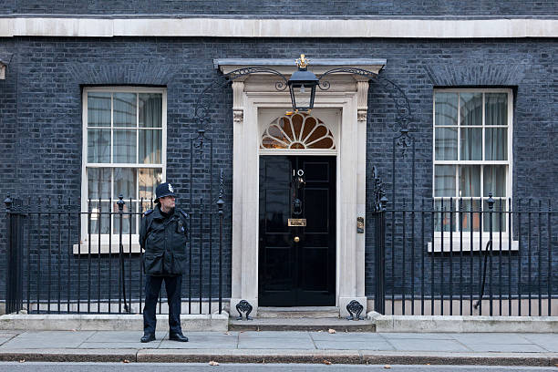 Gusrds at 10 Downing Street London, United Kingdom - November 28, 2016: A guard in front of 10 Downing Street in London, the residence of Prime Minister of the United Kingdom. inner london stock pictures, royalty-free photos & images