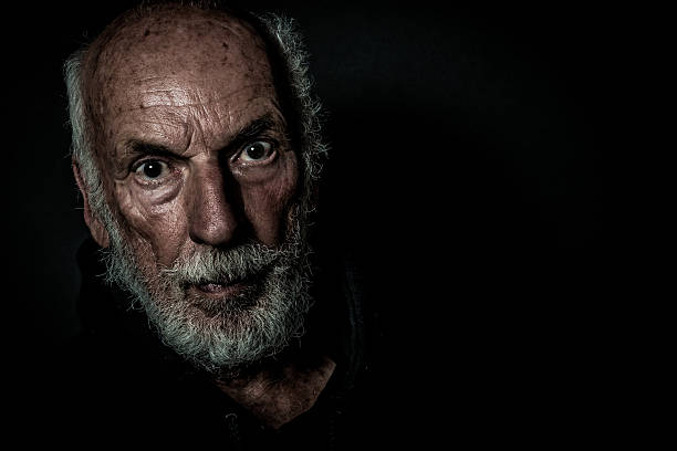 istock Senior Man Portrait, beard,  facial expression, black background 629240072