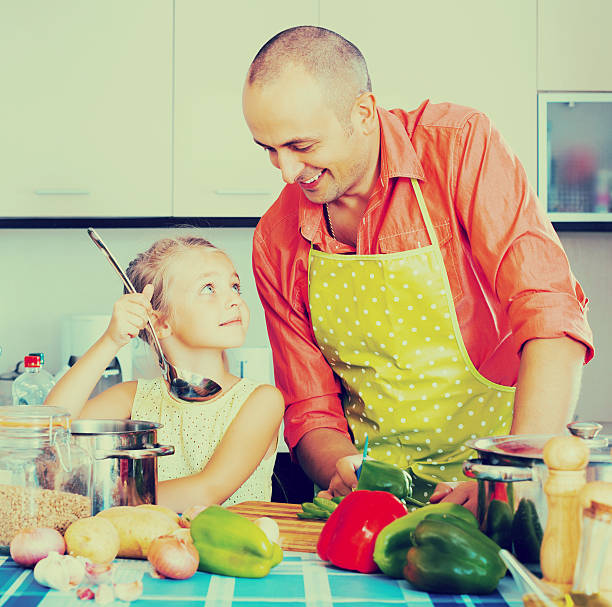 istock Dad and little daughter cooking 629240290
