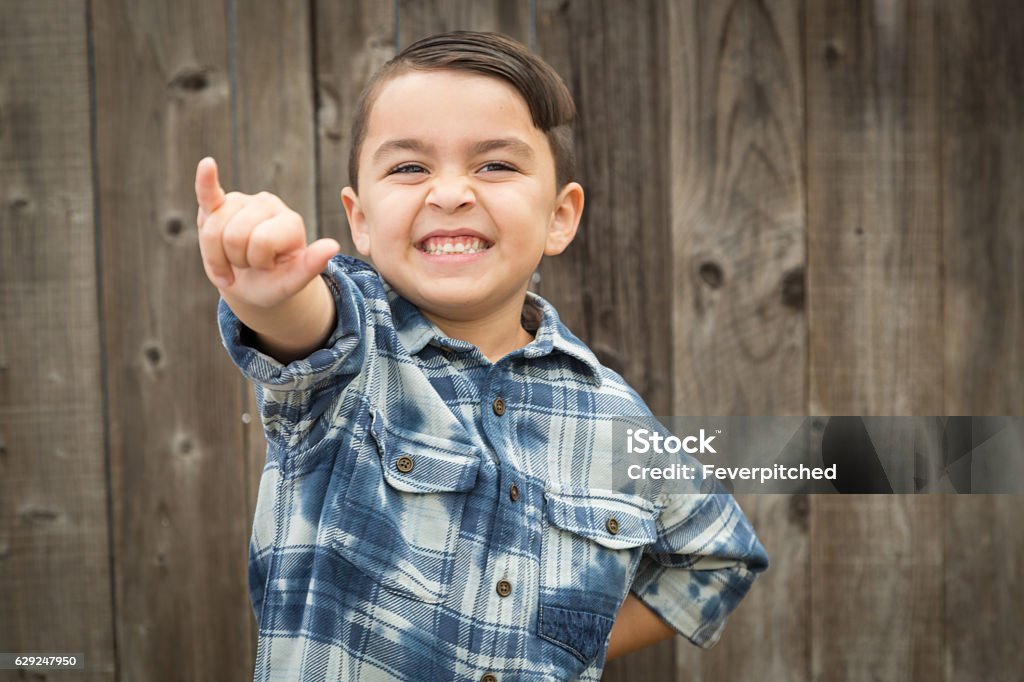 Young Mixed Race Boy Making Shaka Hand Gesture Happy Young Mixed Race Boy Making Hawaiin Shaka Hand Gesture. Child Stock Photo