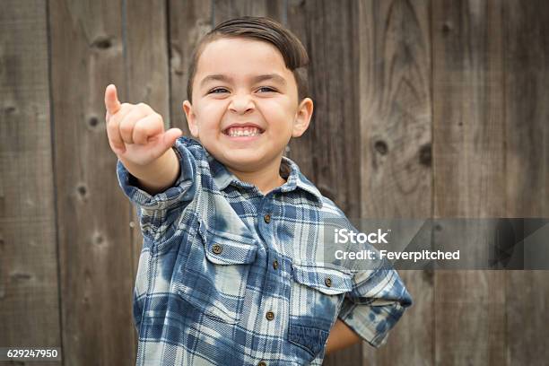 Young Mixed Race Boy Making Shaka Hand Gesture Stock Photo - Download Image Now - Child, Sign Language, Boys